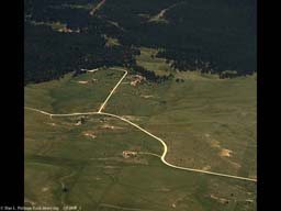 Urban sprawl reaching into forest (aerial), Western USA