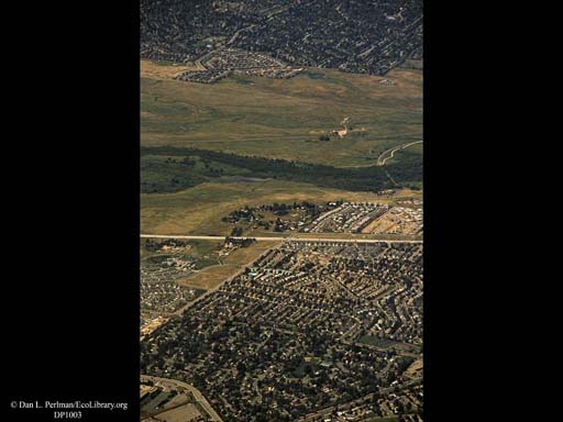 Urbanization closing in on river (aerial), Western USA